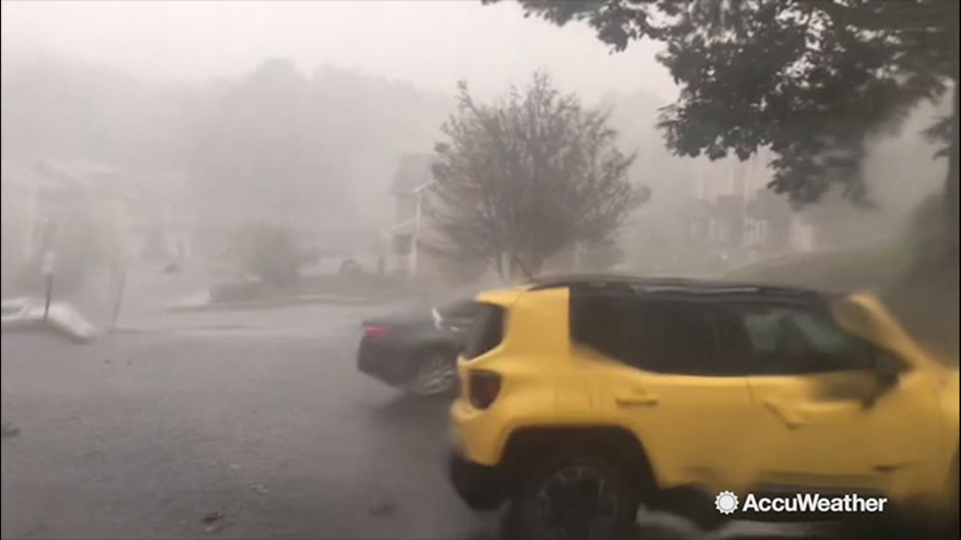 AccuWeather's Carolina Jones and Krissy Pydynowski have provided footage first of hail pelting a neighborhood, then the wind blowing around a light post at the State College Spikes field in State College, Pennsylvania, on Aug. 18.