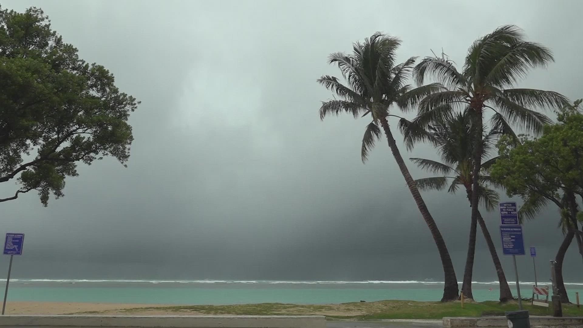 A strong storm packing high winds and extremely heavy rain flooded roads and downed power lines and tree branches across Hawaii Monday.