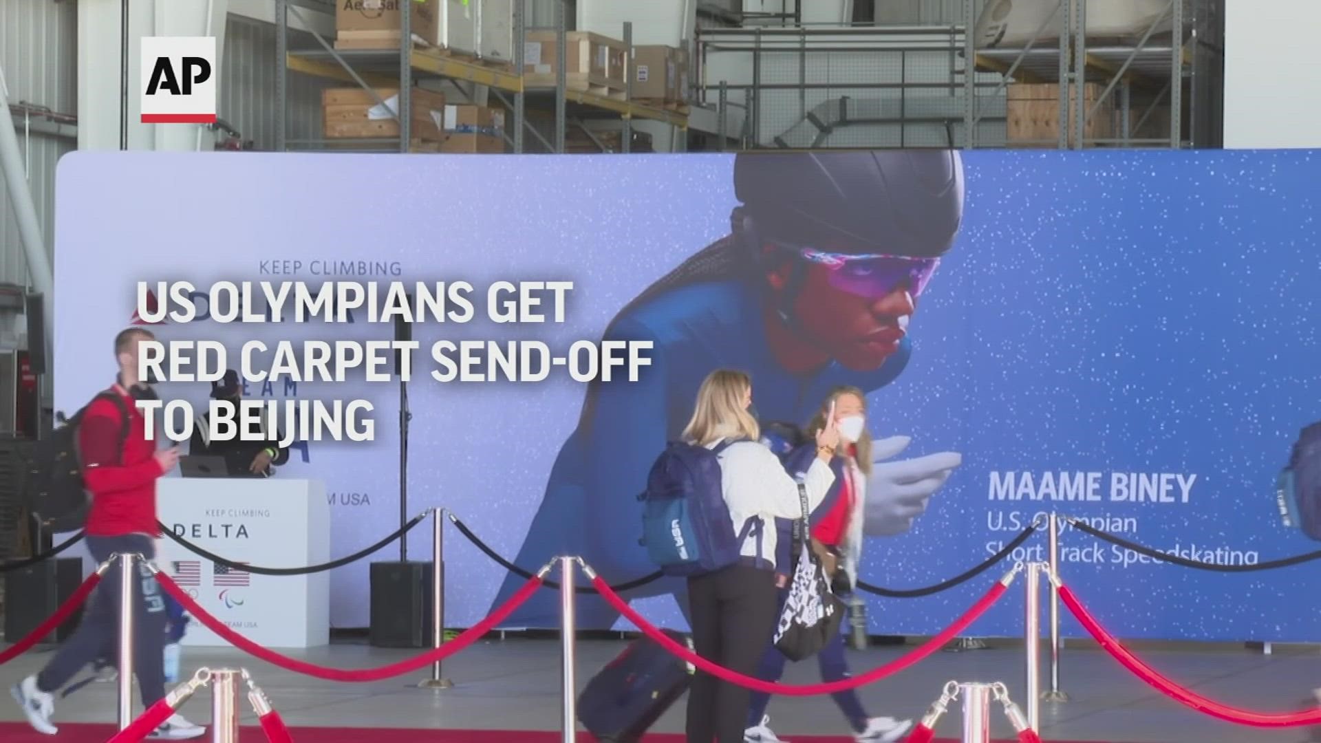 Cowbells rang and tiny US flags waved inside an airplane hanger at LAX as the US Olympic team departed for the Beijing Olympics Thursday morning.