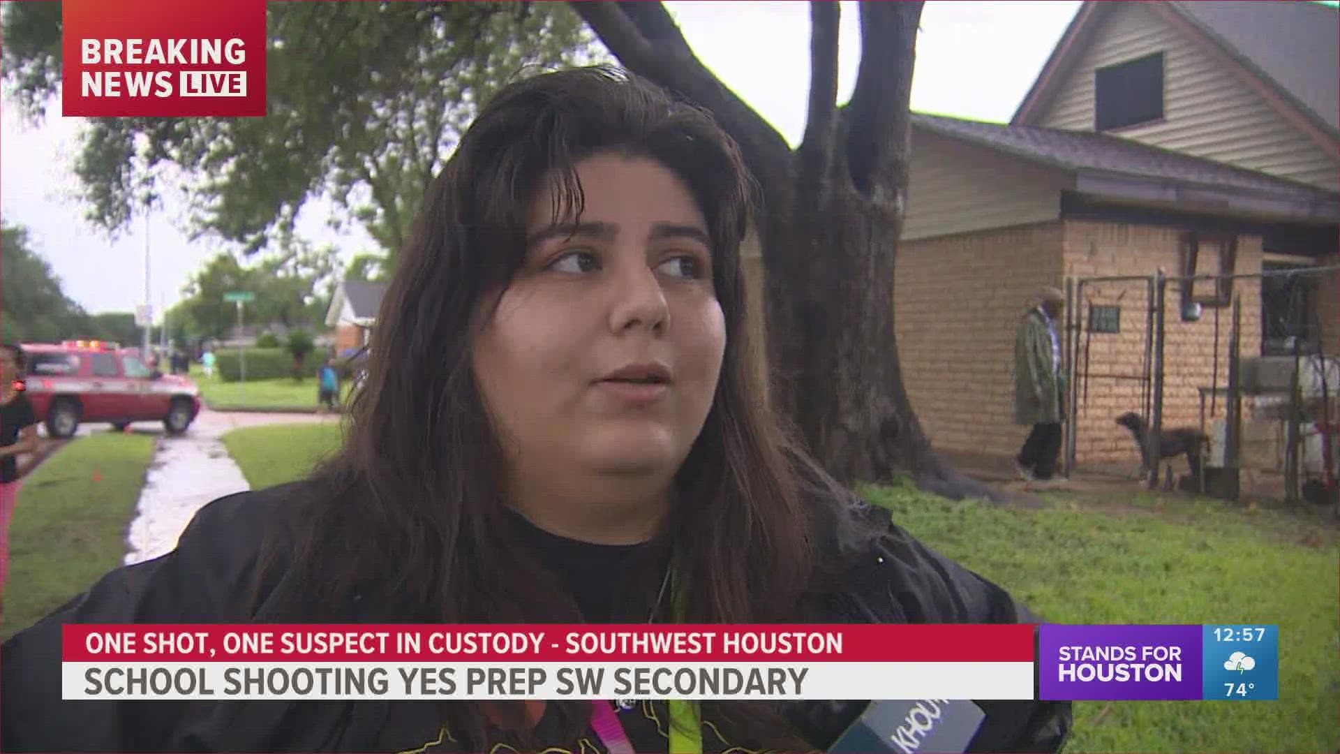 KHOU 11's Marcelino Benito speaks with a student's older sister outside of YES Prep Southwest Secondary, where the shooting took place.