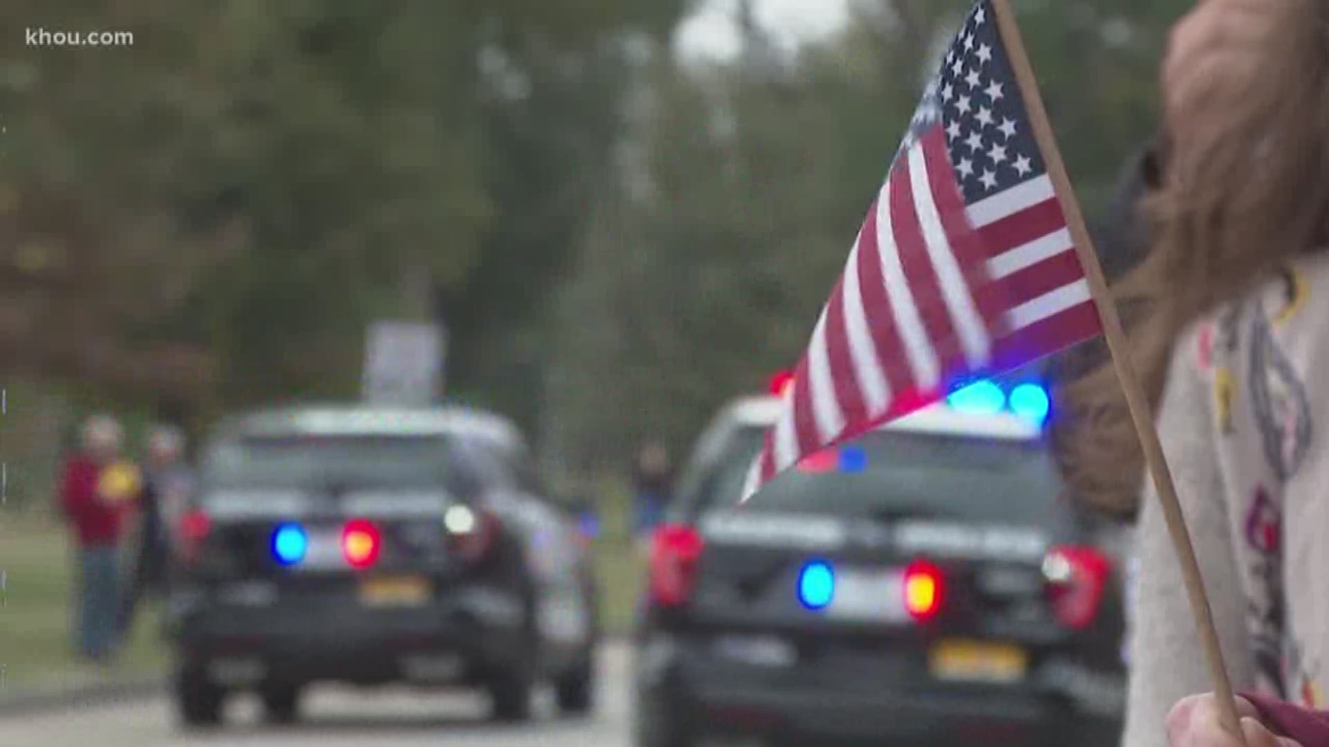 Hundreds stopped at Memorial Park to watch the President Bush's motorcade go by, moments after it left St. Martin?s Episcopal Church Thursday. Todd Lewis arrived early with a large American flag. He wanted to make sure he was in position to say good-bye t