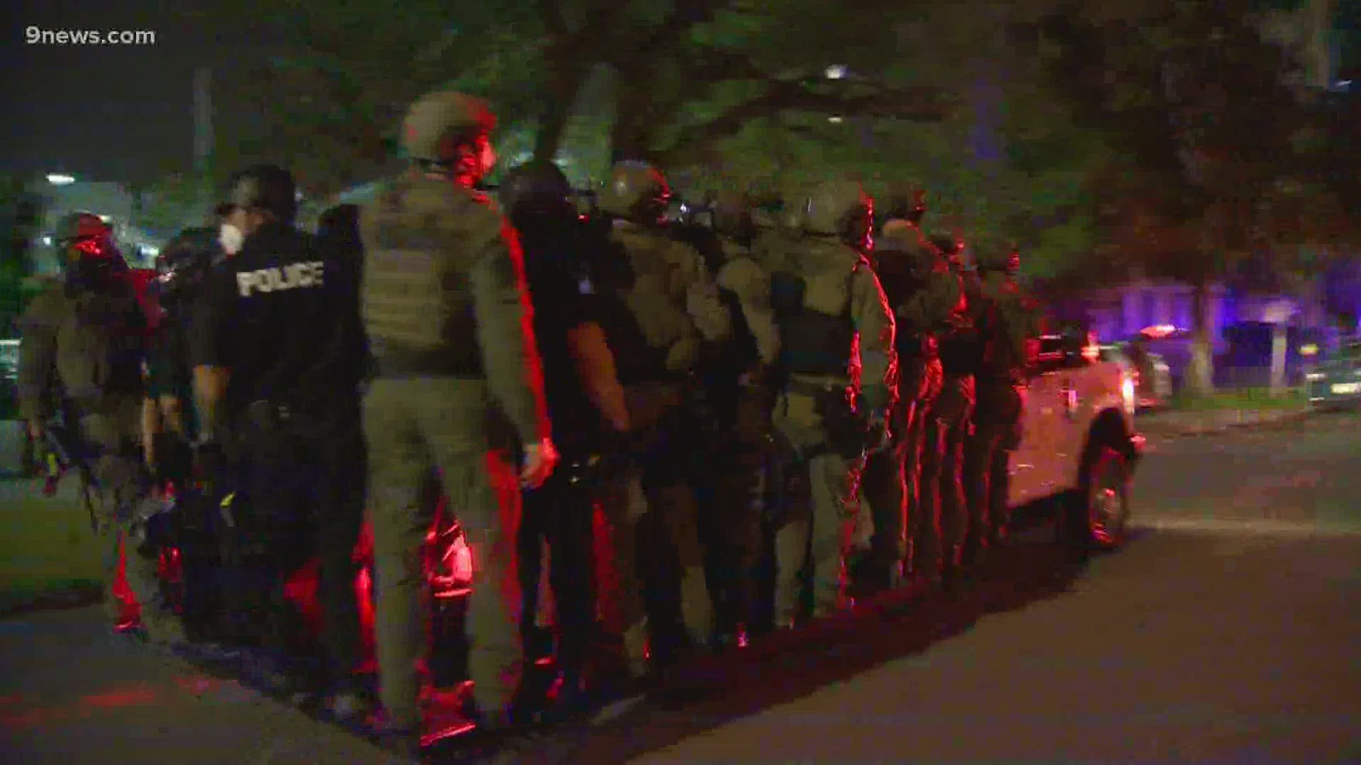 A group with signs was seen marching in downtown Denver and chanting "no justice, no peace" before the protest escalated.