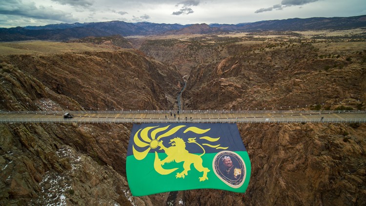 Huge Zamundan flag flown from Colorado suspension bridge