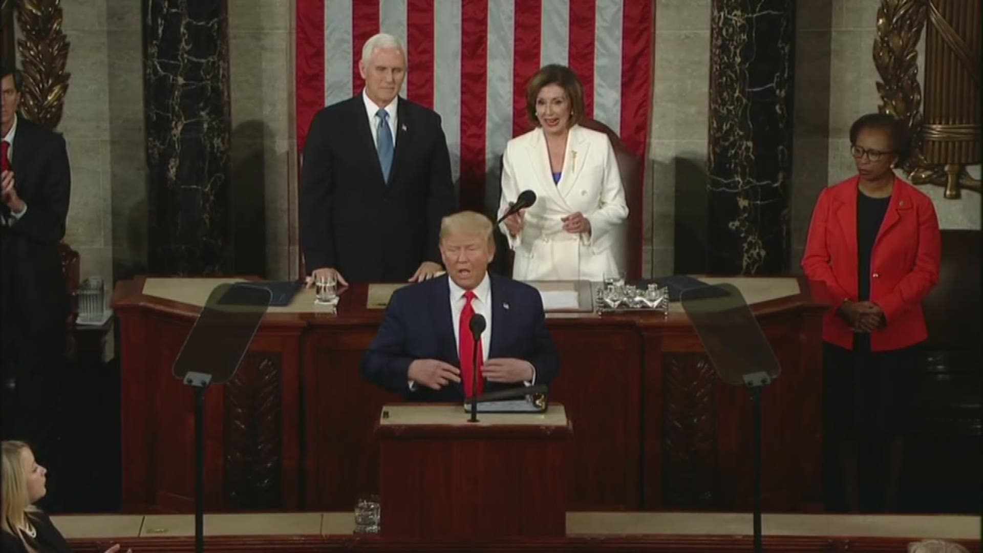 President Donald Trump arrives to the House chamber to deliver his third State of the Union speech, appearing unwilling to shake Speaker Pelosi's hand.