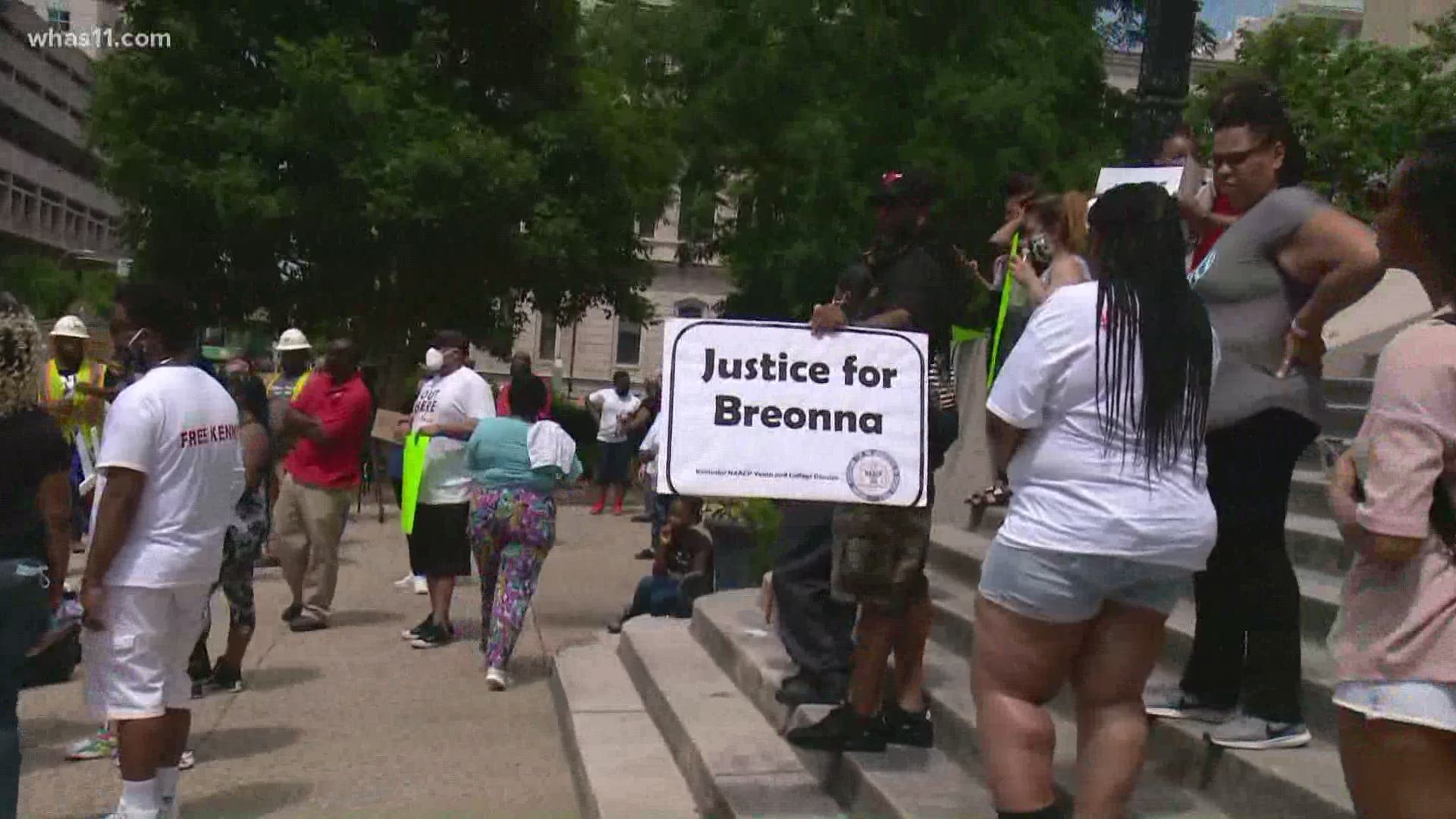 Protesters are gathered outside of Louisville Mayor Greg Fischer's office demanding the prosecution of three officers involved in Breonna Taylor's death.