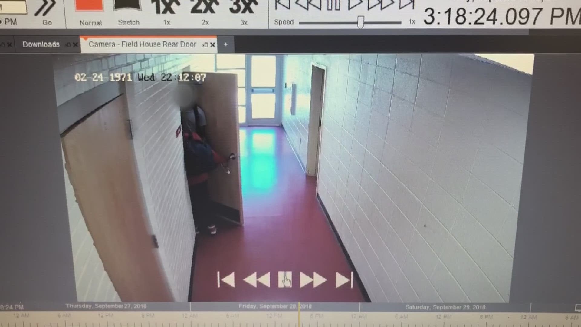 Thomasville High School players are seen hooked up to IV bags on a metal stand while walking in the hallway.