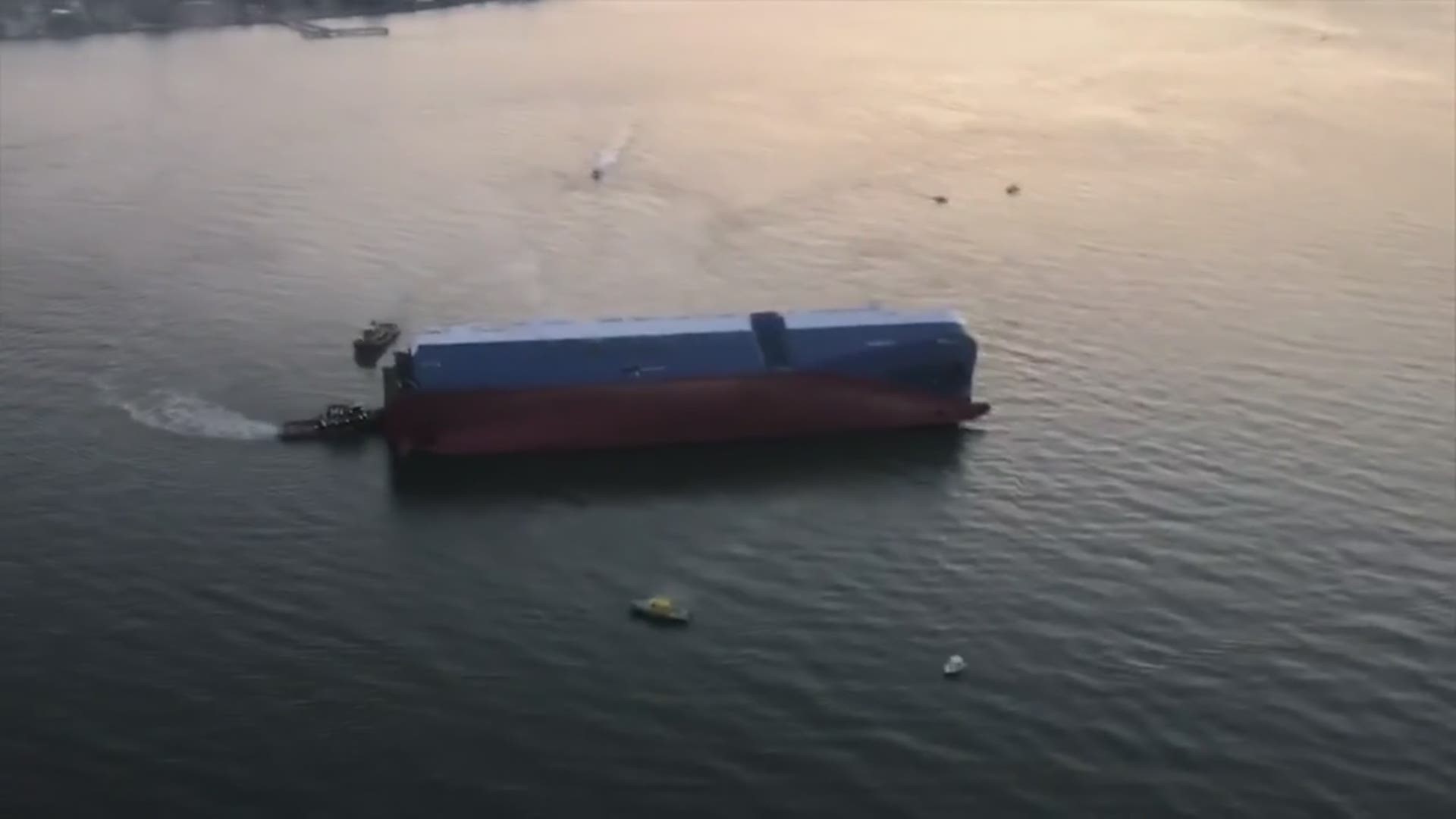 Ariel footage shows smoke emanating from an overturned cargo ship in the St. Simons Sound. Twenty crew members were rescued but four remain unaccounted for. Courtesy of the U.S. Coast Guard District 7 Padet Jacksonville