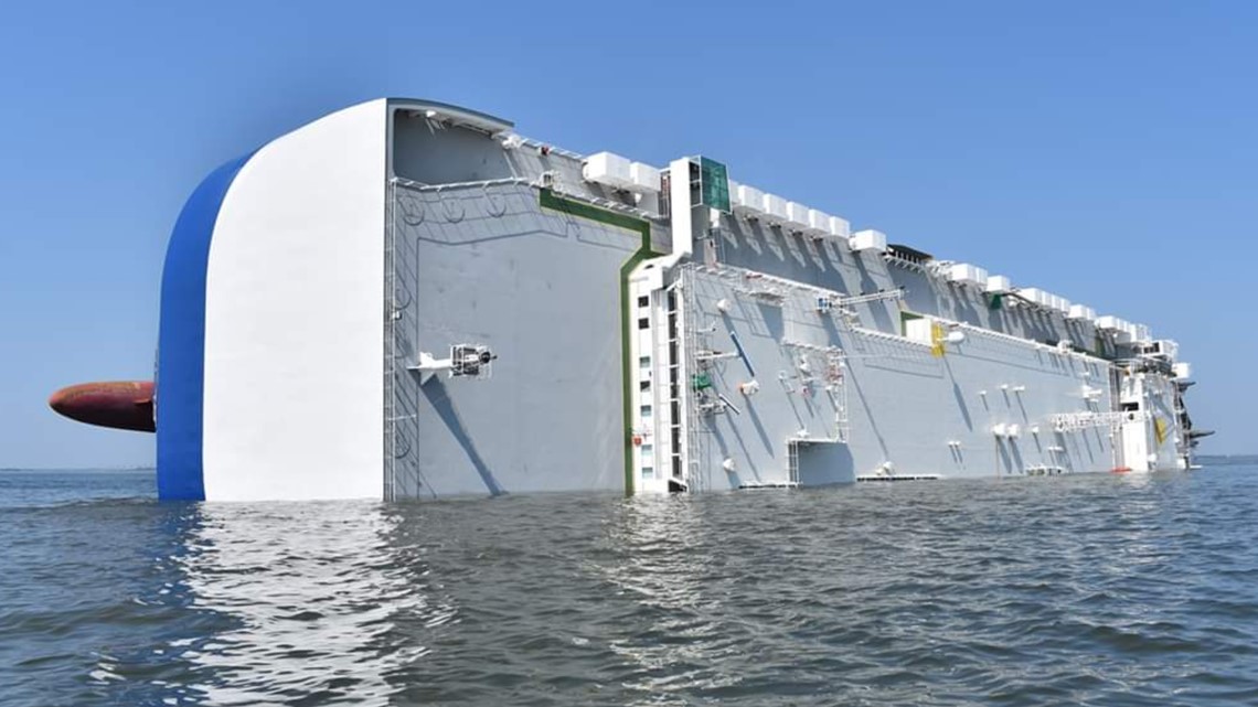 Fire, smoke coming from overturned cargo ship, four missing