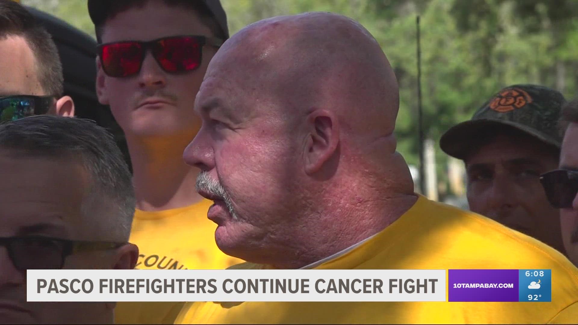 They say the county isn't honoring legislation that entitles a $25,000 cash payout for firefighters diagnosed with cancer.
