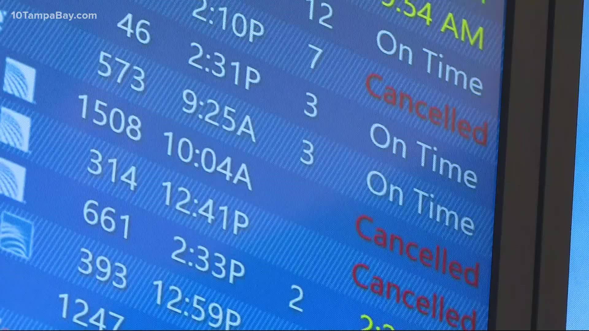 Many travelers at Tampa International are navigating canceled and delayed flights and airlines are pointing to the spread of COVID-19.