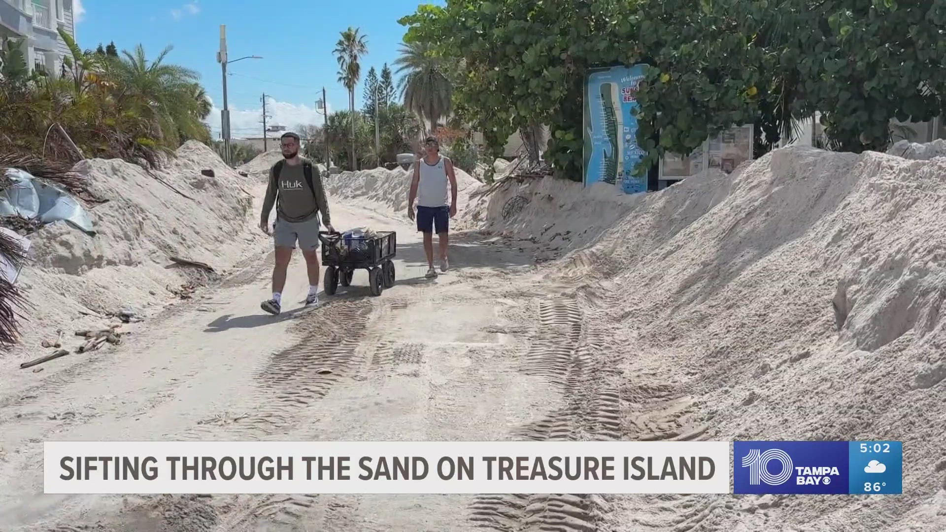 Construction crews, first responders and community members in Treasure Island are working to clear piles of sand brought into the area from Helene.