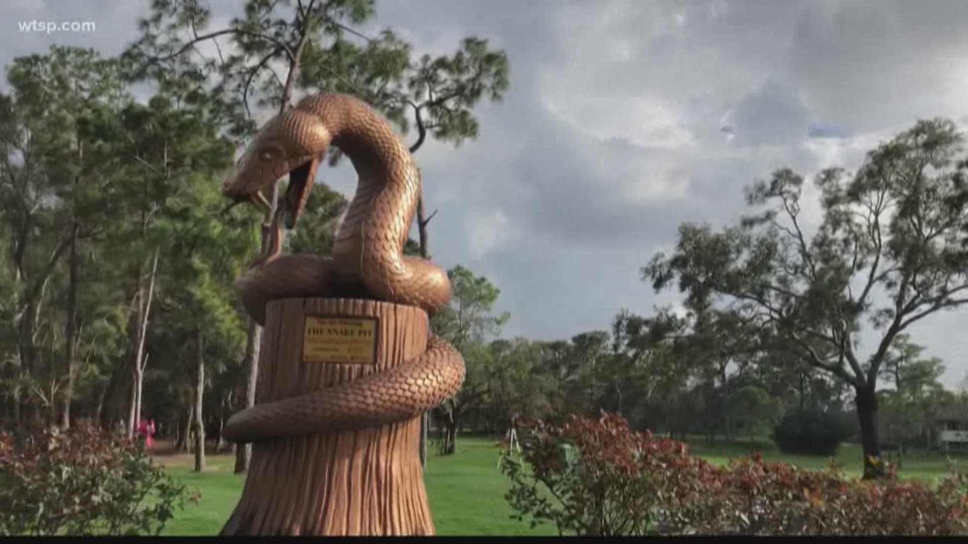 Fans at the Valspar tournament take photos at the iconic "Snake Pit" statue.