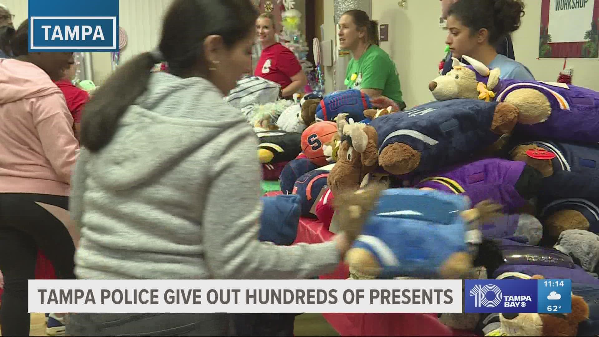 Tampa police officers give out hundreds of presents to kids at the housing authority.