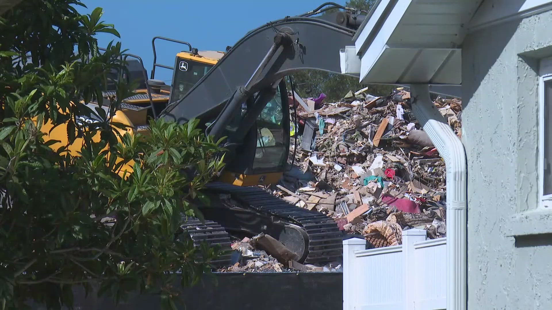 The massive debris pile is located behind the Magnolia Valley neighborhood in New Port Richey, where residents say they have health concerns.