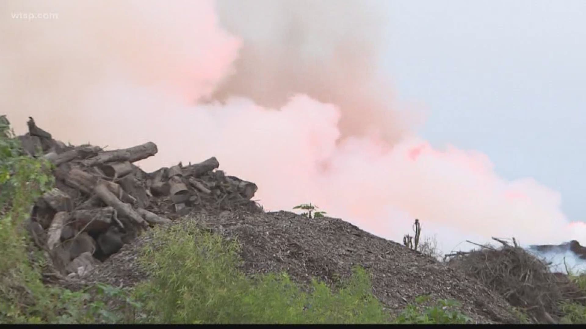 A large fire continues burning into the morning at a Polk County wood recycling facility.