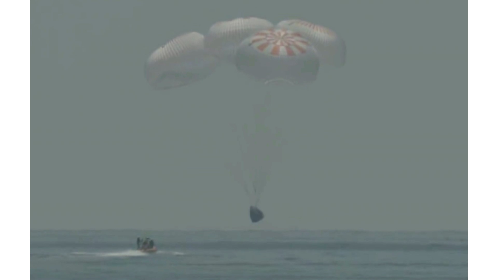 Two NASA astronauts returned to Earth on Sunday in a dramatic, retro-style splashdown, their capsule parachuting into the Gulf of Mexico.