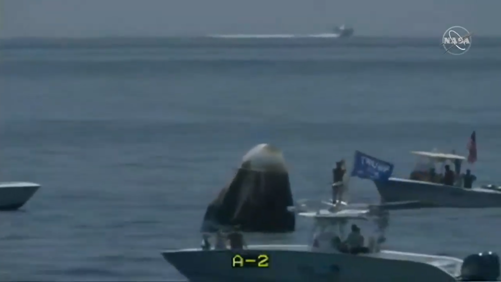 SpaceX's recovery team radioed out to the boaters in an attempt to get them away from the Crew Dragon capsule.