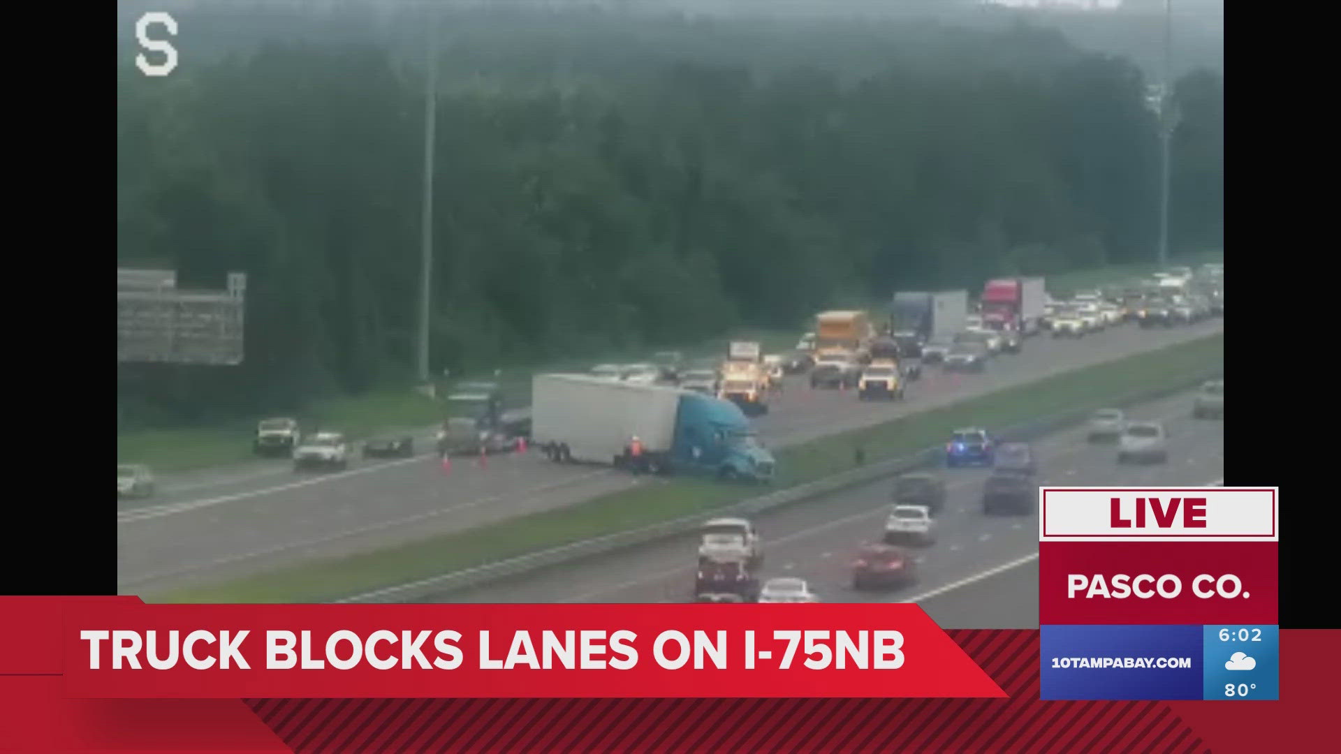 Traffic cameras appear to show at least one semi-truck stopped across the highway.