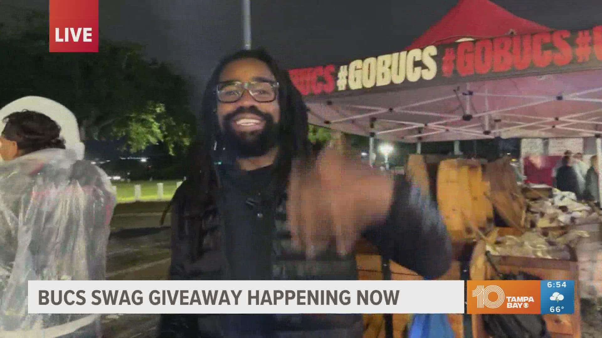 Early Friday morning, Tampa Bay fans can receive free Bucs swag at a drive-thru event at Raymond James Stadium's south parking lots.