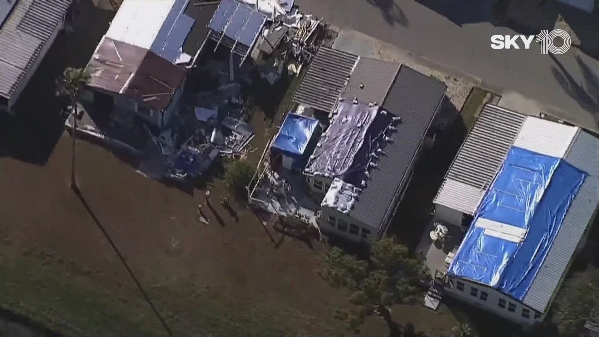 Thousands of blue tarps have been installed on damaged roofs.