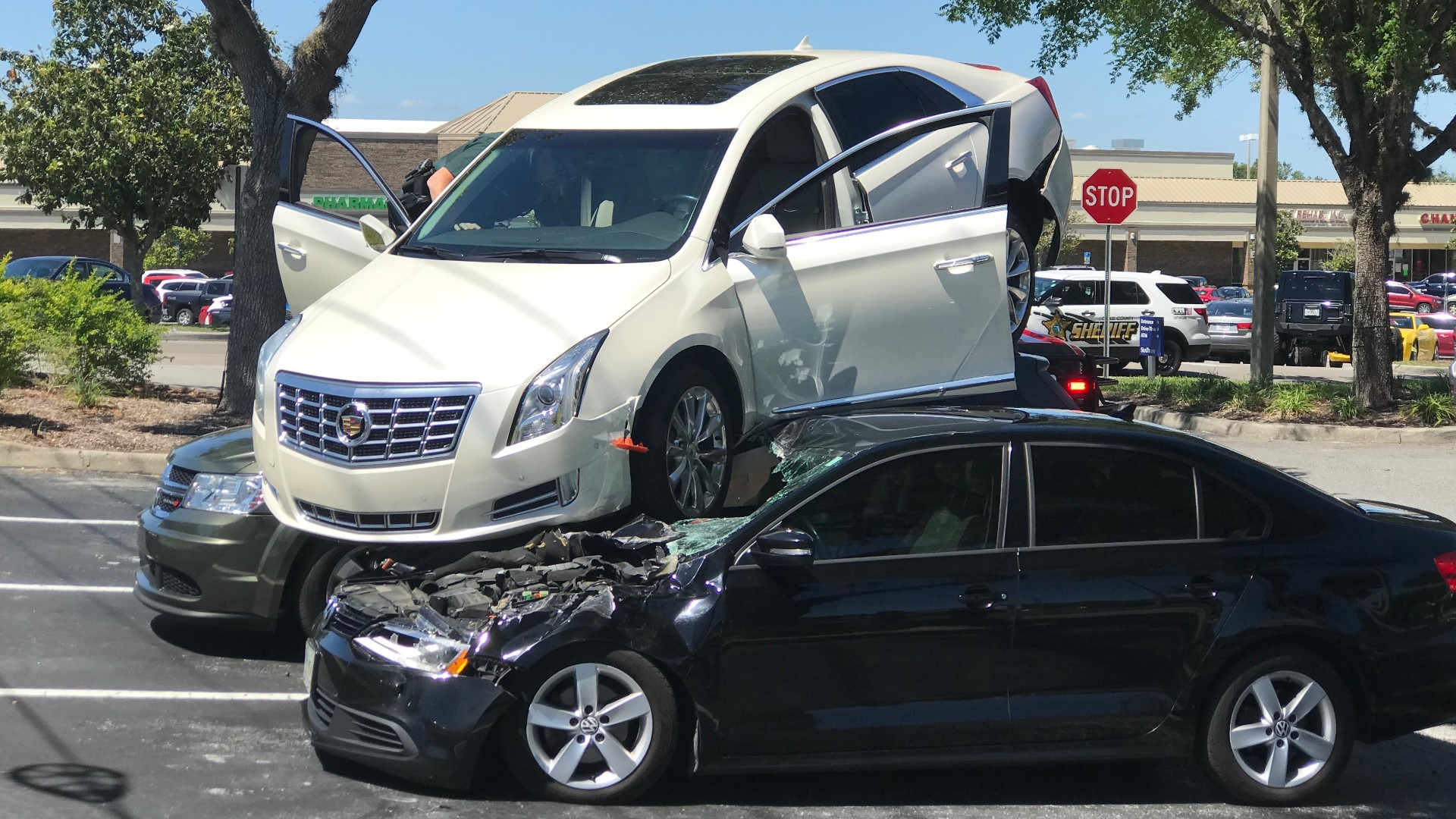 Citrus County driver backs up onto two parked cars at bank