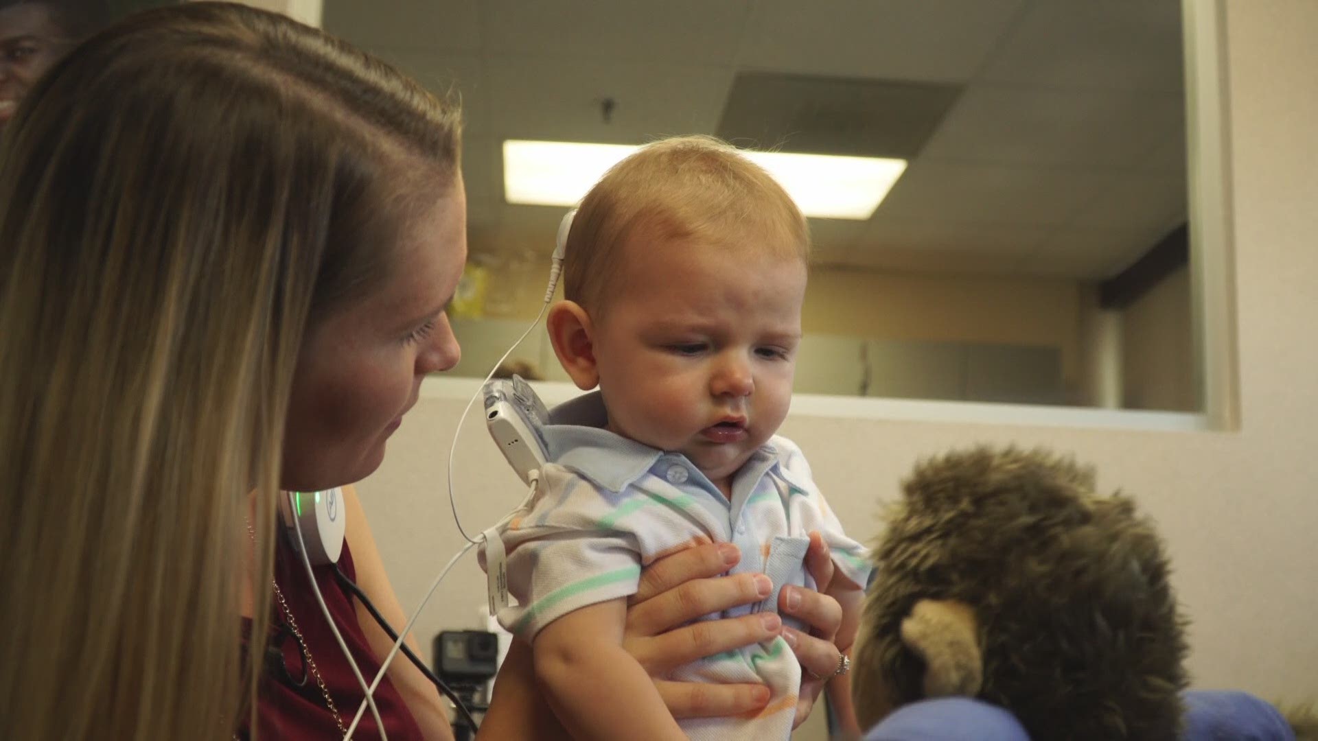 Brady Burley, who lives with Connexin 26 Disorder, heard for the first time thanks to a Cochlear implant from Dr. Loren Bartels.