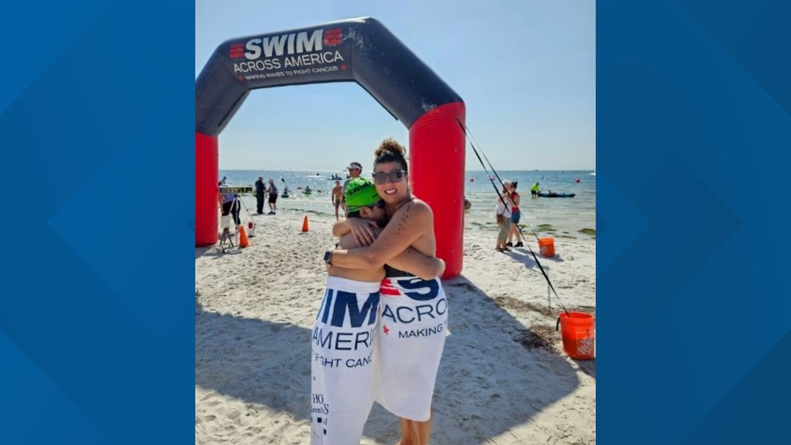 Mother celebrates being cancer free by swimming at Swim Across America event with son