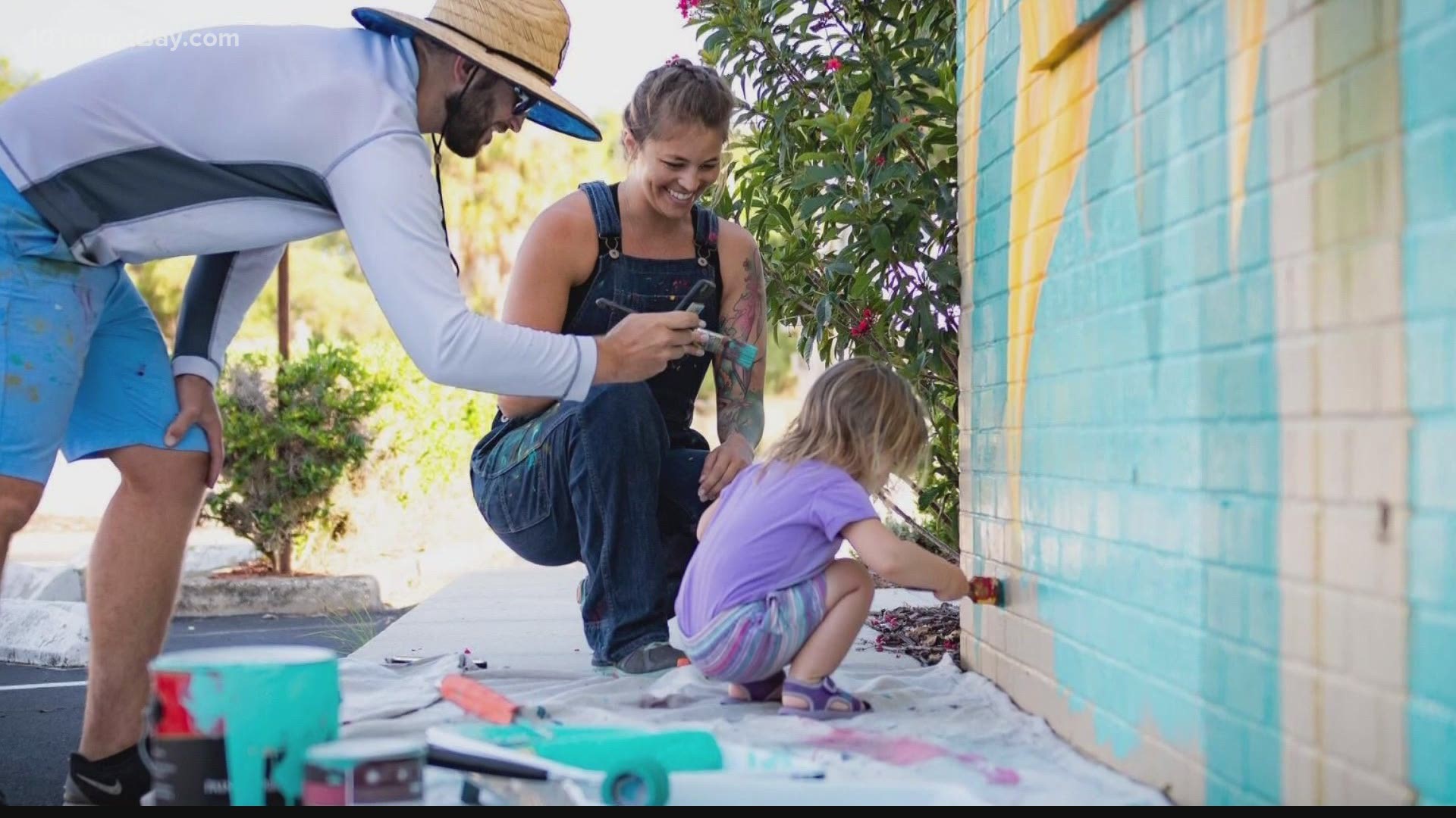 Muralists Braden Everly and his wife, Alyssa, are inviting the community to help them paint a giant color-by-number mural to show unity in their neighborhood.
