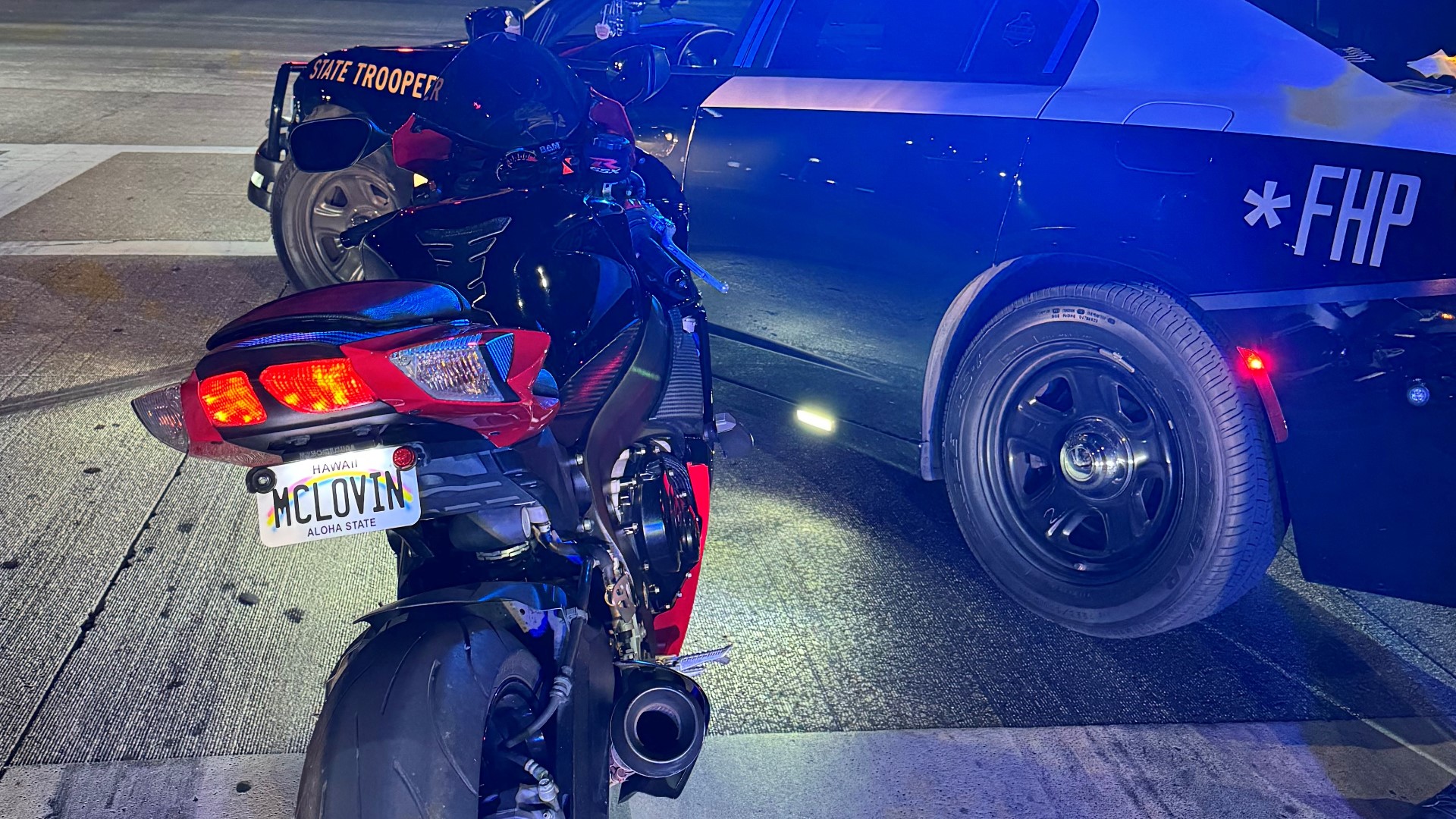 A man was arrested after he was caught speeding on a motorcycle with a fake "McLovin" plate and didn't stop, FHP said.