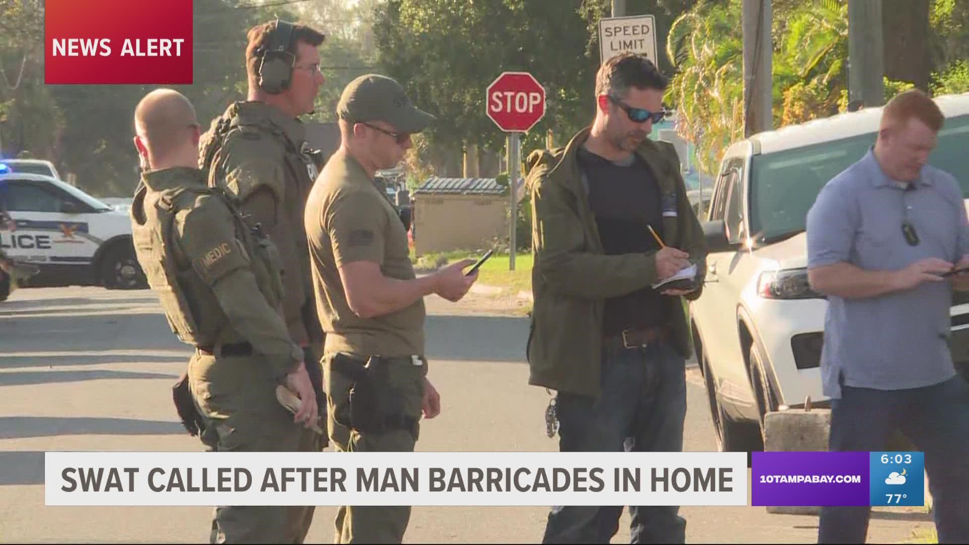 After officers spotted a car connected to area break-ins, a man ran into a nearby home and barricaded himself.