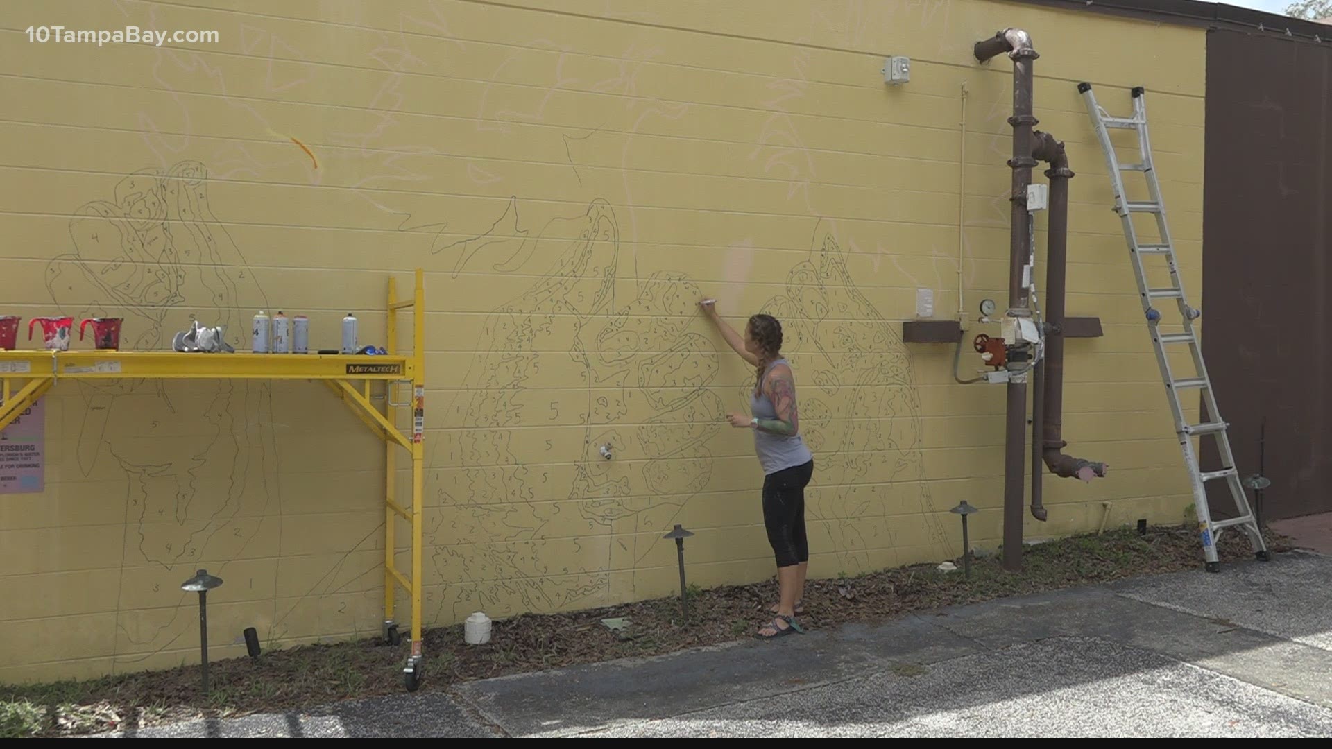 Braden and Alyssa expected a few dozen volunteers to help them paint a sunflower mural designed to bring unity to St. Pete. They got over 200 requests to help paint.