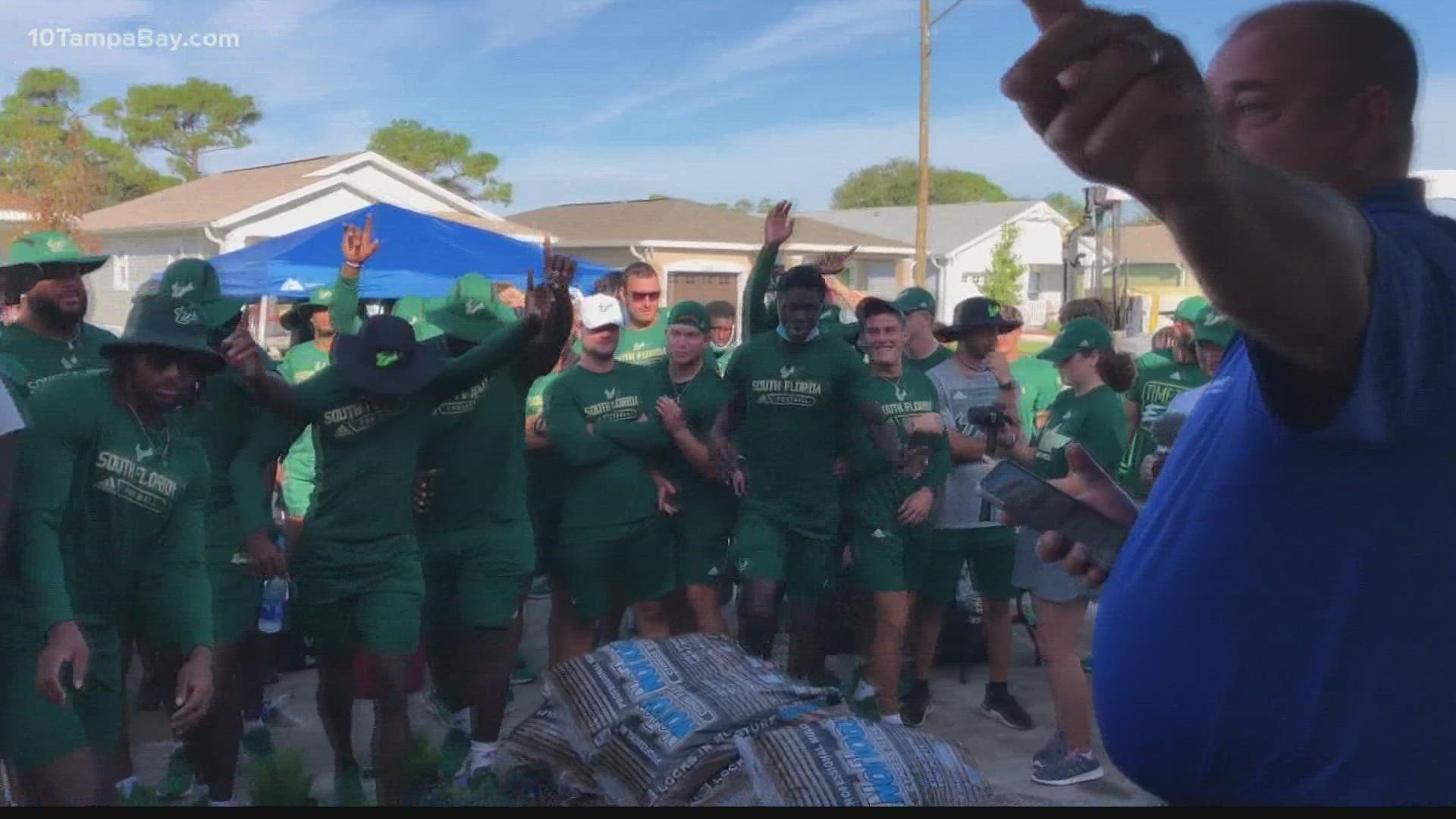 The football team traded in their pads and cleats for shovels and hammers to build a home with Habitat for Humanity.