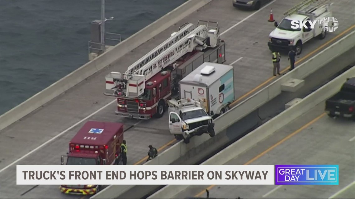 Maintenance truck's front end hops Skyway Bridge barrier