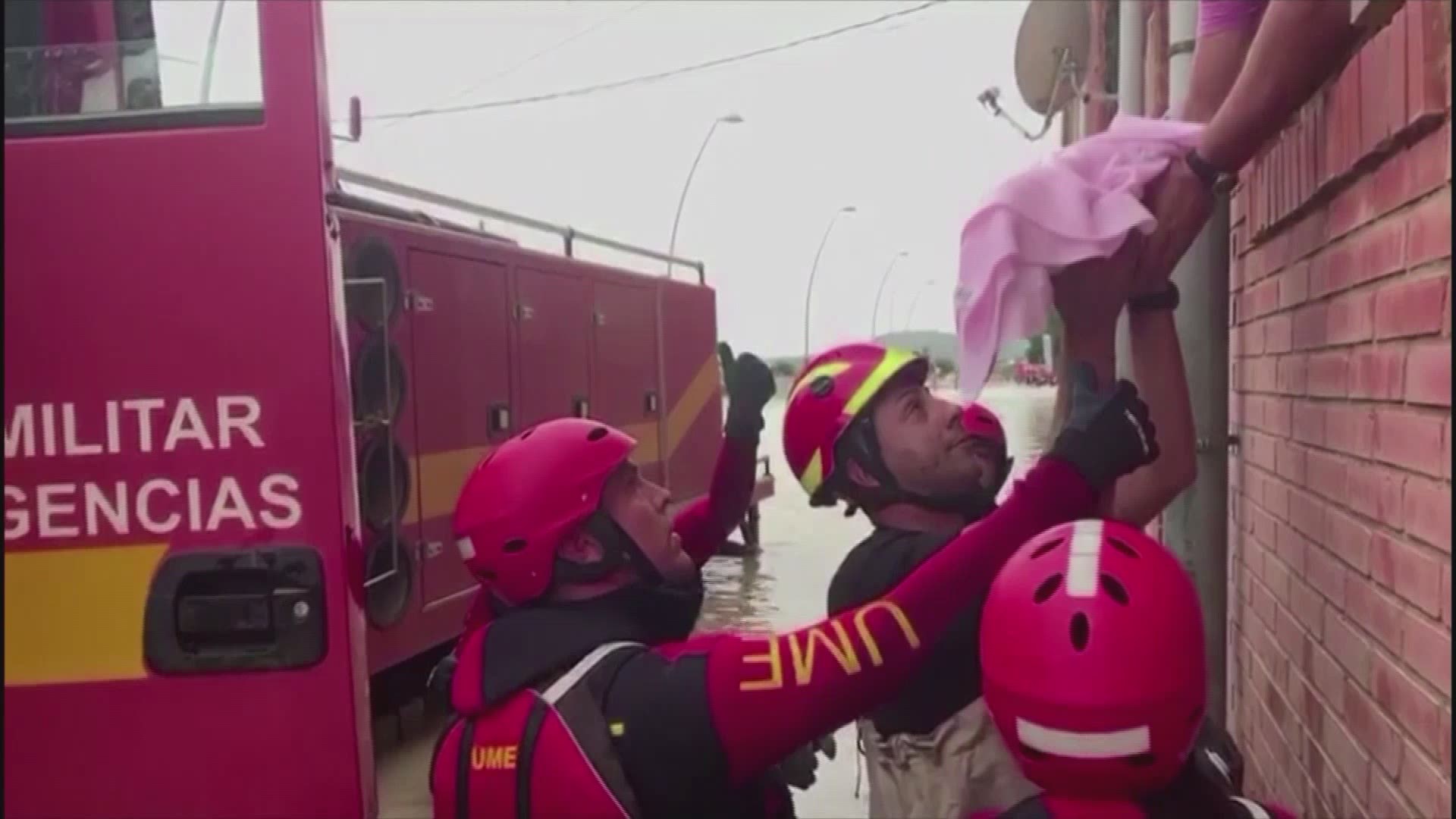 As rescue operations continued late Saturday in southeast Spain, a baby had to be passed to waiting soldiers as waist-high waters prevented a family from escaping an apartment building.