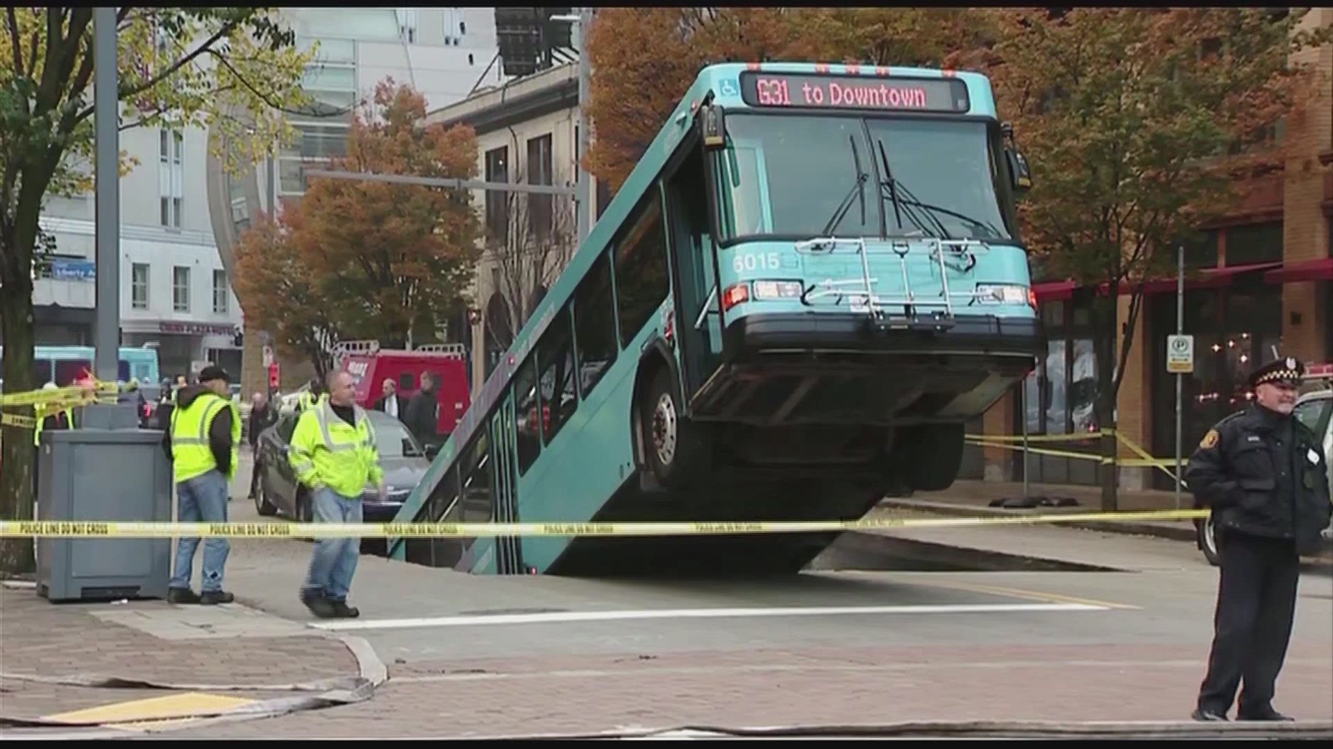 A massive sinkhole opened up in downtown Pittsburgh Monday morning, swallowing a portion of a Port Authority bus and nearly a car as well.