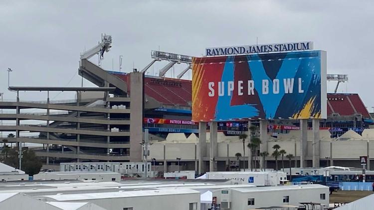 A video board at Raymond James Stadium shows a Salute to Service