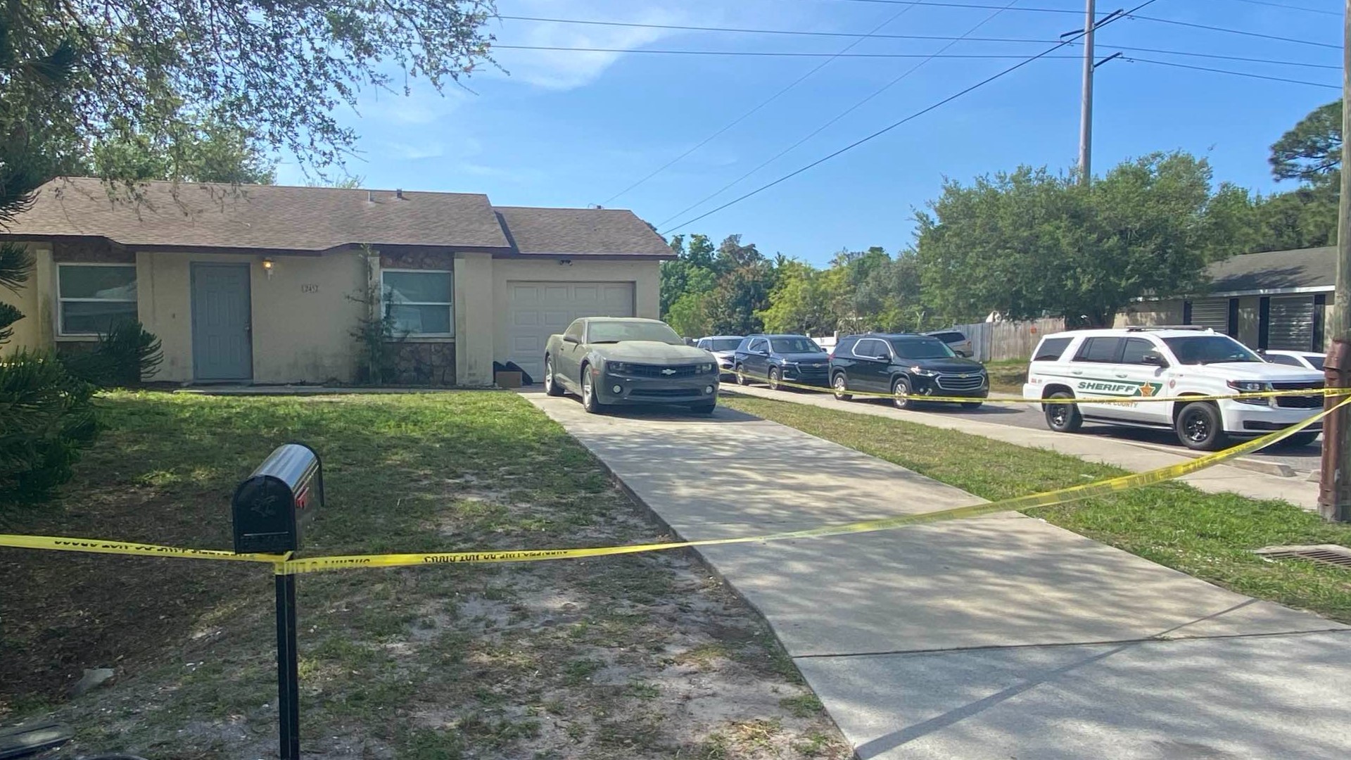 Almost 10 hours after someone said a bullet hit their TV, a dead body was found nearby. Investigators are trying to figure out how they're connected.