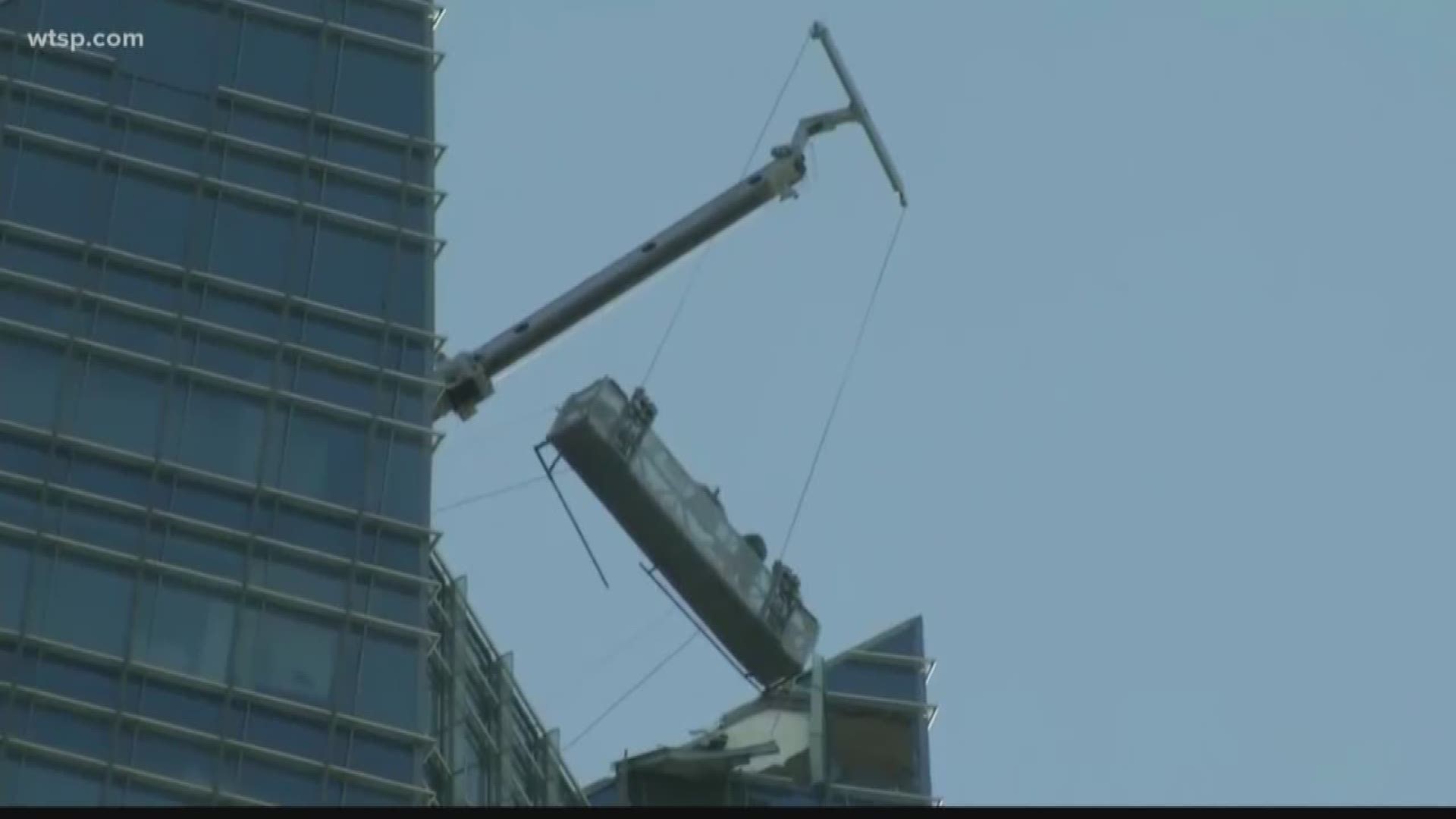 The workers were stuck on a swinging lift on the top of an Oklahoma City skyscraper. Also, terrifying video shows a helicopter spinning into the Hudson River.