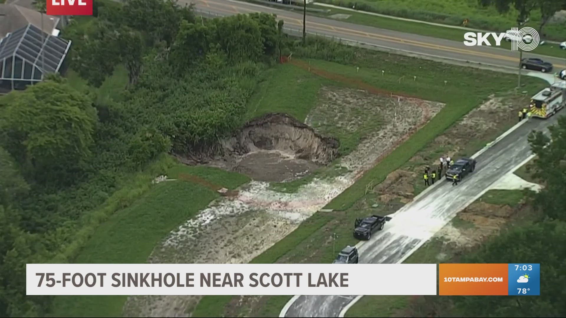 Scott Lake Road at Fitzgerald Road is closed and will be blocked off at least until midday Saturday as workers try to stop the expansion of the 75-foot sinkhole.