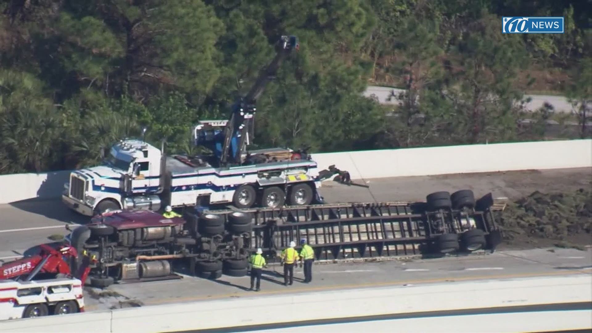 Crews worked to remove an overturned semi-truck and clean up its contents from Interstate 275.