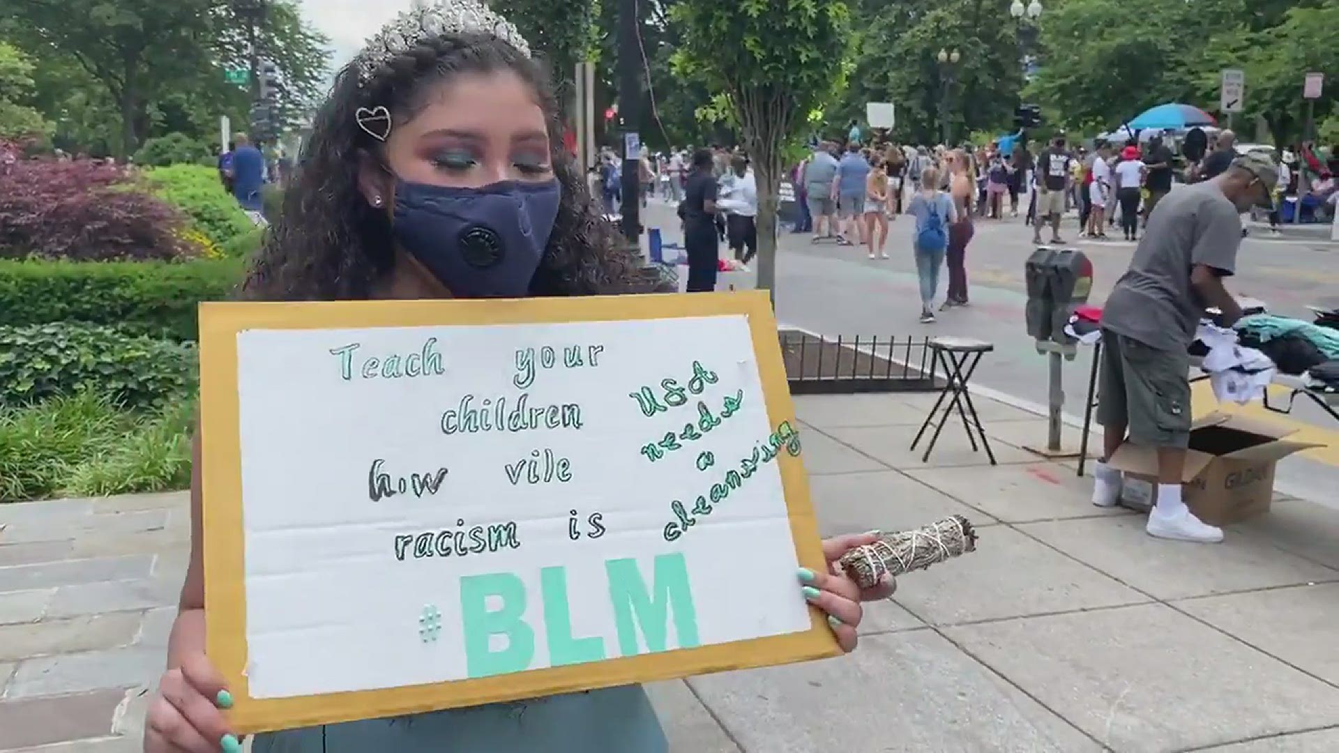 She’s came to BLM Plaza to take her quinceñera pictures, holding sage and protesting.