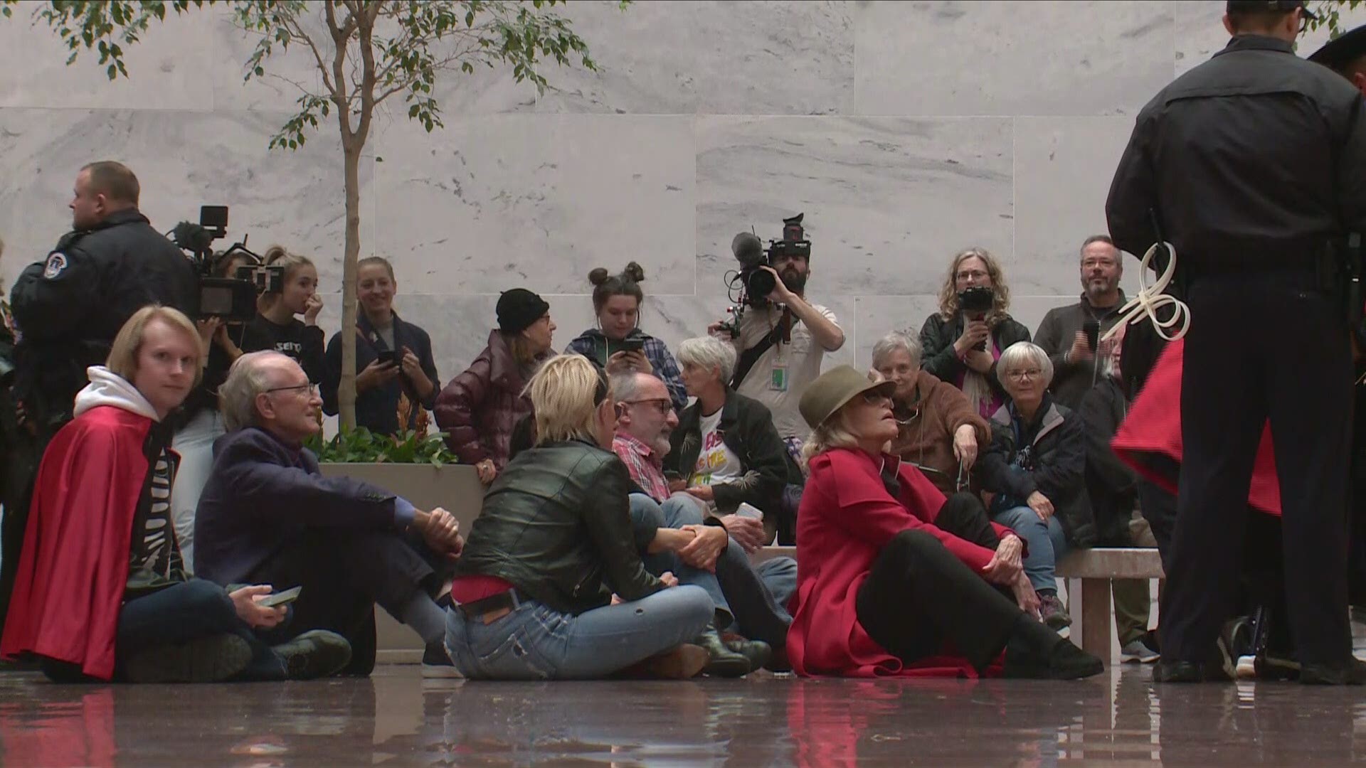 Jane Fonda continues her routine Friday arrest at the the Hart Senate Office Building during a climate change protest.