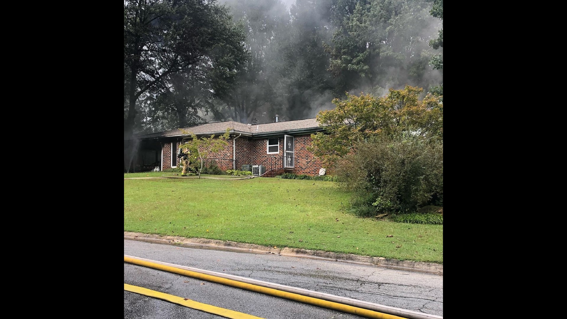 Smyrna house fire burns as officer prays with homeowner
