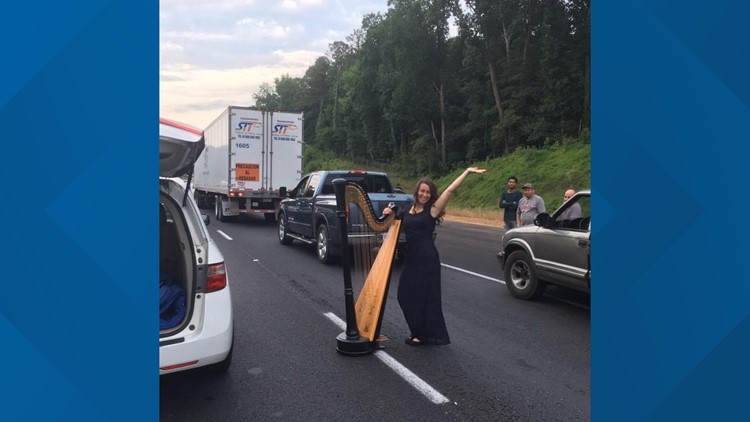 Woman plays harp in the middle of traffic jam on Georgia interstate